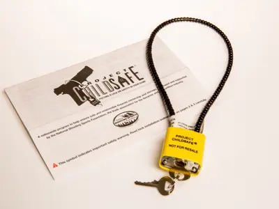 An image of a channel lock sitting on top of a flyer for the gun saftey program, Project Childsafe. 